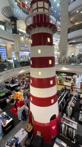 Bangkok mall features lighthouse decoration among clothing displays