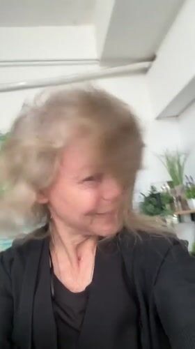 Woman films morning scenes around Ramat Gan market area