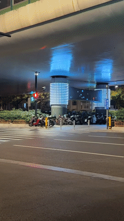 Nighttime traffic flows through illuminated Shanghai intersection April 21