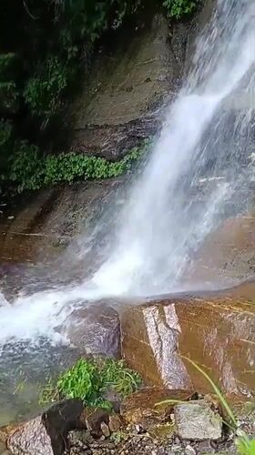 Visitor documents peaceful waterfall scenes in Vashisht, India