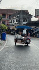 Woman operates motorcycle cart through Patong streets