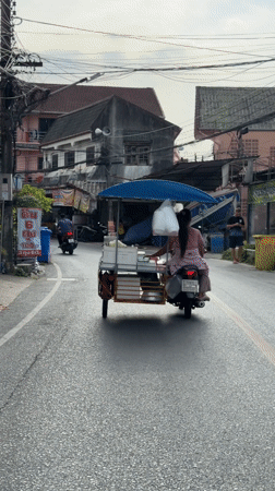 Woman operates motorcycle cart through Patong streets