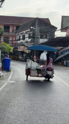 Woman operates motorcycle cart through Patong streets