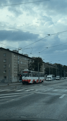 Rainy city streets, a tram, and food cooking over coals