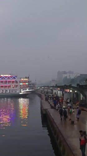 Ferry passengers disembark in foggy Dhaka terminal