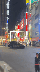 Nighttime pedestrian crossings documented at busy Shinjuku intersection