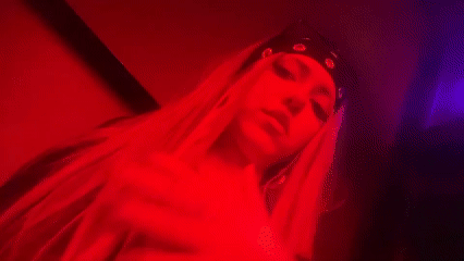 Late-night dancing at a Milan nightclub under red lights