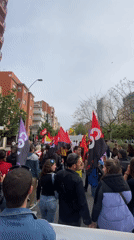 Political demonstration with flags and banners marches through Barcelona