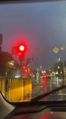 Evening rain creates reflective streets in Minsk traffic