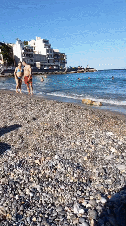 Lazy afternoon on a pebble beach in Agios Nikolaos, Crete
