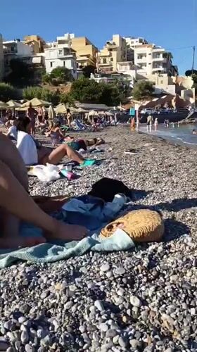 Lazy afternoon on a pebble beach in Agios Nikolaos, Crete