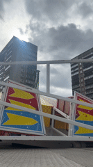 Carnival rides operate in Riga park under cloudy skies