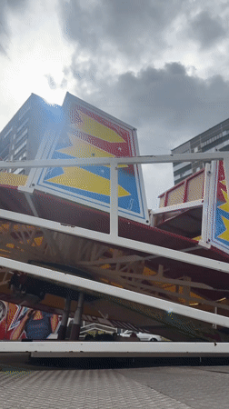 Carnival rides operate in Riga park under cloudy skies