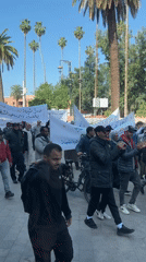 Demonstrators march with Arabic banners in Marrakesh
