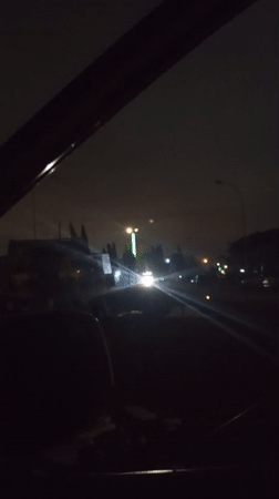 Late-night road scenes in Aso, Nigeria, featuring traffic and billboards