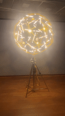 Spherical light sculpture installation observed in Amsterdam gallery