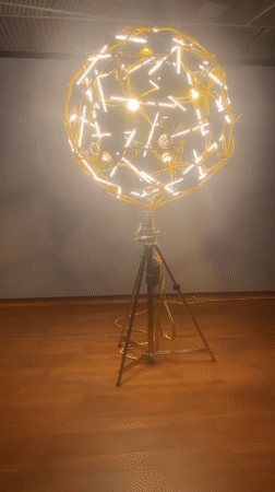 Spherical light sculpture installation observed in Amsterdam gallery
