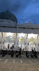 Daily life documented around Lhokseumawe mosque during prayer time