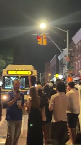 Large street crowd gathers around Tesla in NYC