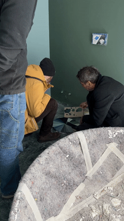 Workers select paint colors during bathroom renovation in Erba
