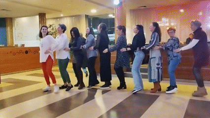 Nine women perform traditional line dance in Sofia hotel lobby