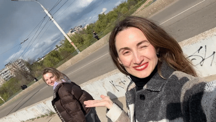 Women photograph spring moments on Kryvyi Rih bridge, riverbank