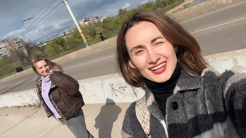 Women photograph spring moments on Kryvyi Rih bridge, riverbank