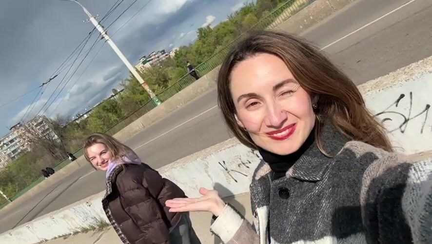 Women photograph spring moments on Kryvyi Rih bridge, riverbank