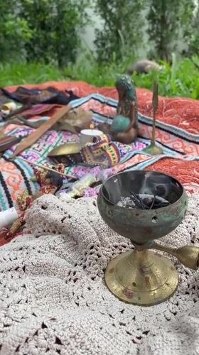 Outdoor altar with burning incense observed on Koh Phangan
