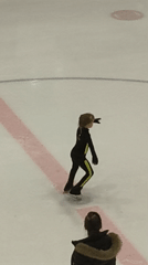 Child meets skating instructor on Riga ice rink