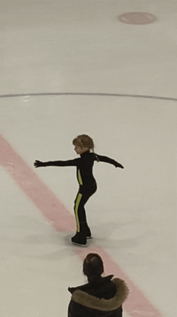 Child meets skating instructor on Riga ice rink