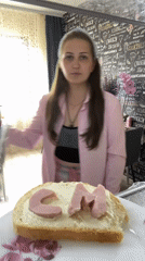 Woman prepares lettered bread in Russian kitchen