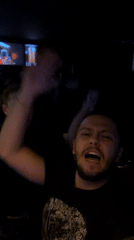 Excited person films themselves at indoor gathering in Sofia