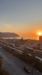 Truck traffic backed up along Hopa's coastal highway at sunset