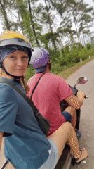 Motorcycle riders travel winding roads in Vietnamese countryside
