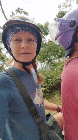 Motorcycle riders travel winding roads in Vietnamese countryside