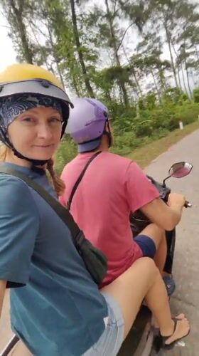 Motorcycle riders travel winding roads in Vietnamese countryside