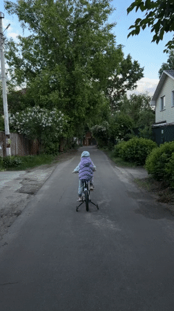 Child learns cycling, ducks swim at dandelion-lined Russian lake