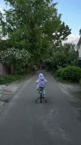 Child learns cycling, ducks swim at dandelion-lined Russian lake