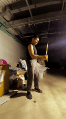 Nunchaku practice in a dim Karaganda basement, yellow nunchucks mid-swing