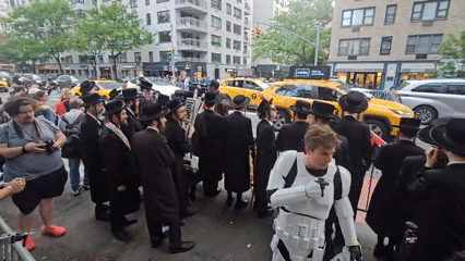 Diverse groups gather behind barriers on NYC street