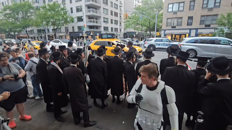 Diverse groups gather behind barriers on NYC street