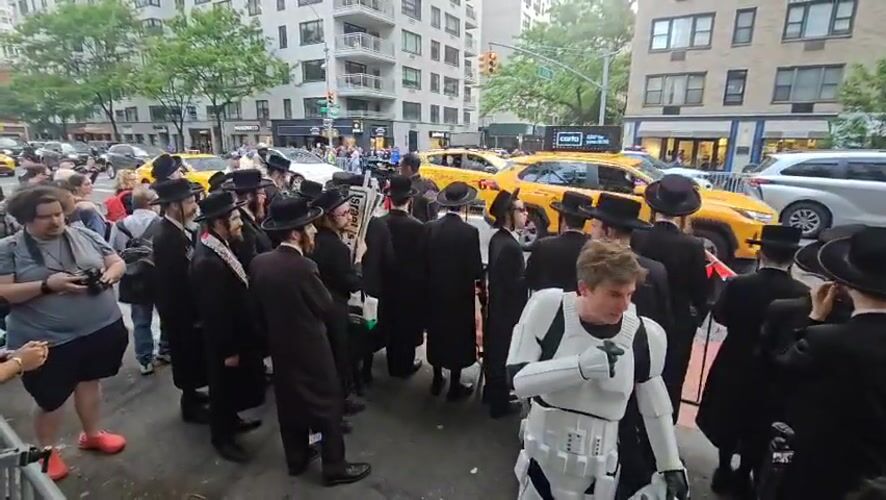 Diverse groups gather behind barriers on NYC street