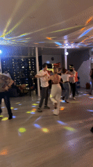 Group dancing with colored lights in Sochi room