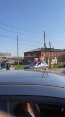 Patriotic gathering with flags and banner in Russian village