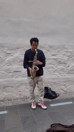 Saxophone session against a stone wall in Lima