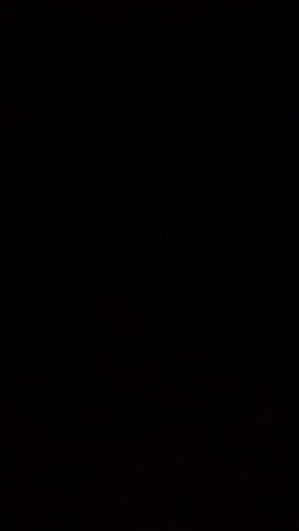The video consists of a black screen with a single green dot appearing briefly in the upper-left quadrant.