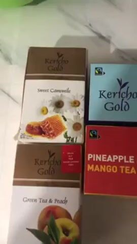 The video shows six boxes of Kericho Gold tea. There is a box of Sweet Camomile, Green Tea & Peach, Green Tea Mint, Pineapple & Mango Tea, Raspberry, and Fruit Tea Assortment. The boxes are arranged on what appears to be a white marble or stone surface. There is background noise that sounds like a fan or some other type of motor running.