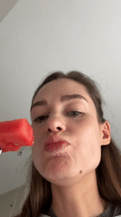 Woman enjoys watermelon breakfast in Kiel, Germany