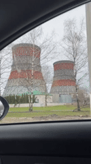 Striped cooling towers filmed from car in Cheboksary, Russia